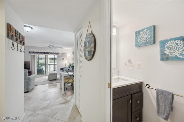 bathroom with tile patterned flooring, ceiling fan, and vanity