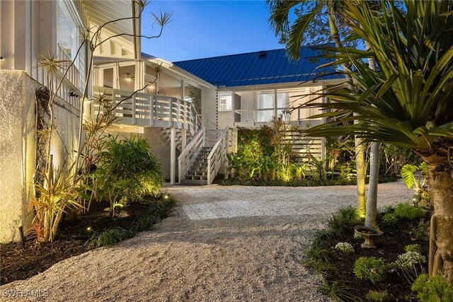 exterior space with covered porch and stairway