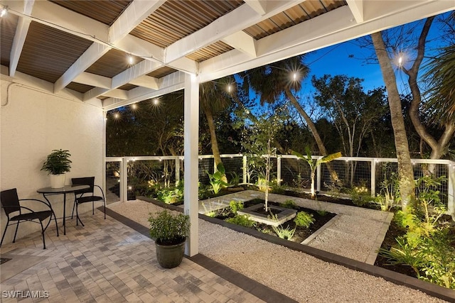 view of patio / terrace with a vegetable garden and fence