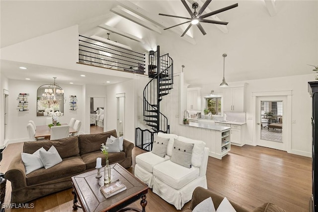 living area with stairs, high vaulted ceiling, and dark wood finished floors