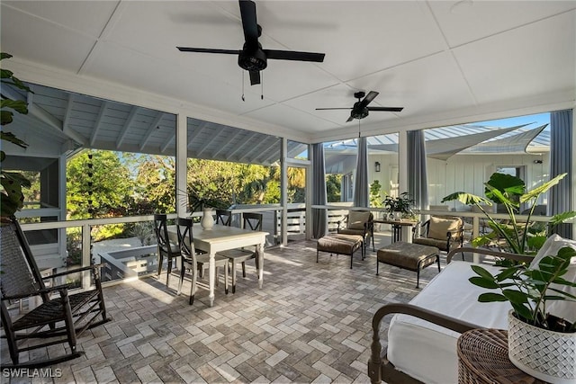 sunroom / solarium with a healthy amount of sunlight and ceiling fan