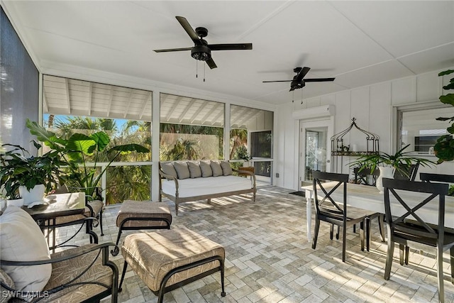 sunroom featuring ceiling fan