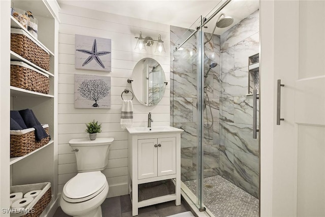 bathroom with toilet, vanity, and a marble finish shower