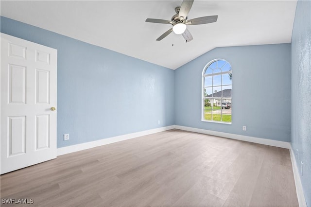 unfurnished room with ceiling fan, light hardwood / wood-style flooring, and vaulted ceiling