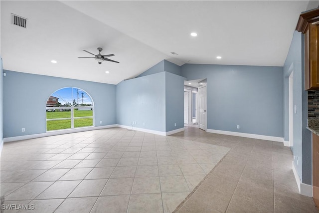 unfurnished living room featuring ceiling fan, light tile patterned floors, and vaulted ceiling