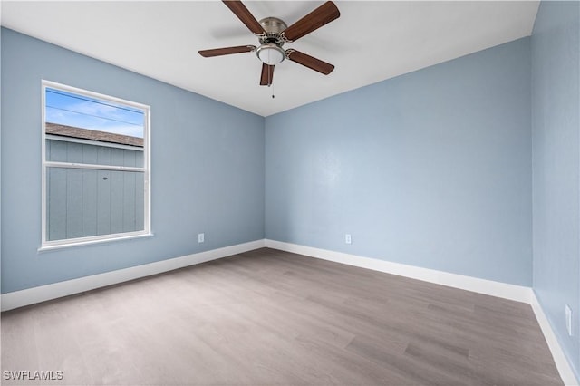 empty room featuring ceiling fan and hardwood / wood-style floors