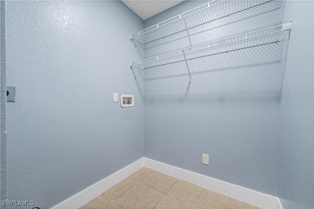 laundry area featuring hookup for an electric dryer, hookup for a washing machine, and tile patterned floors