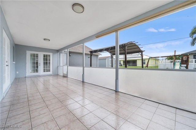 unfurnished sunroom with french doors