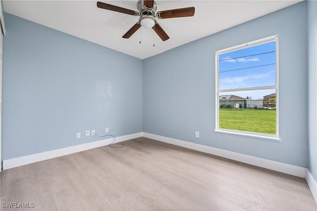 spare room with ceiling fan and light wood-type flooring