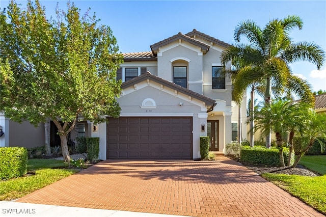 mediterranean / spanish home featuring a garage