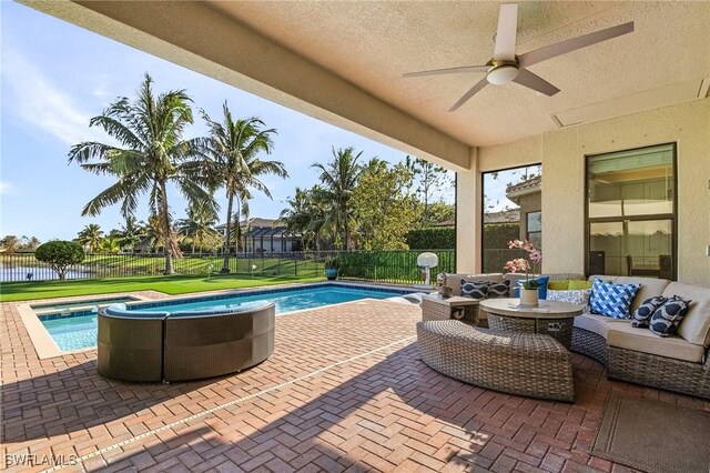 view of swimming pool with outdoor lounge area, ceiling fan, and a patio area