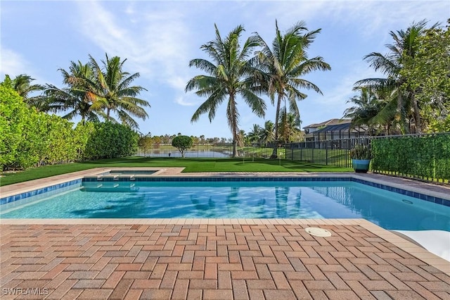 view of pool with a lawn and a water view