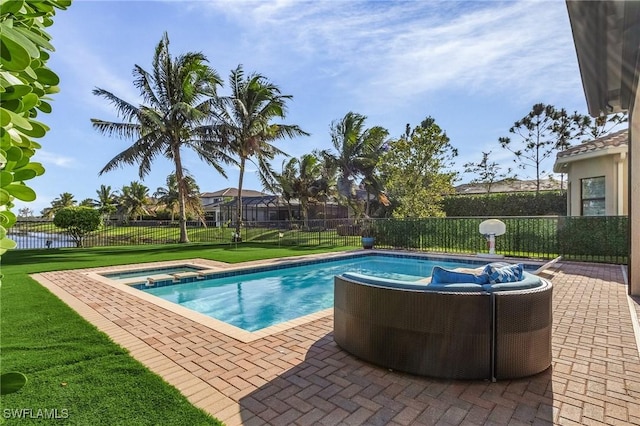 view of pool featuring an in ground hot tub, a patio, and a lawn