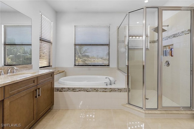 bathroom featuring tile patterned floors, independent shower and bath, and vanity