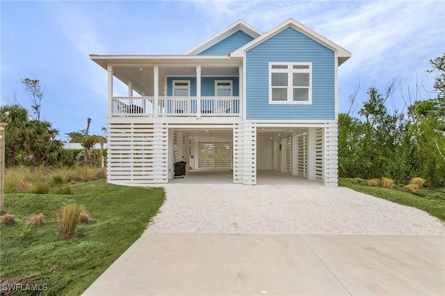 coastal inspired home featuring a porch and a carport