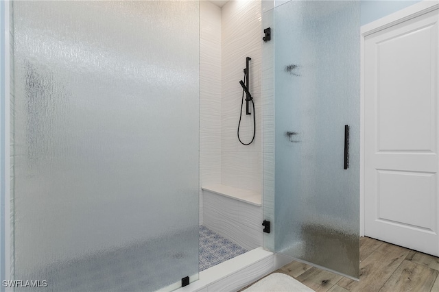 bathroom with a shower and wood-type flooring