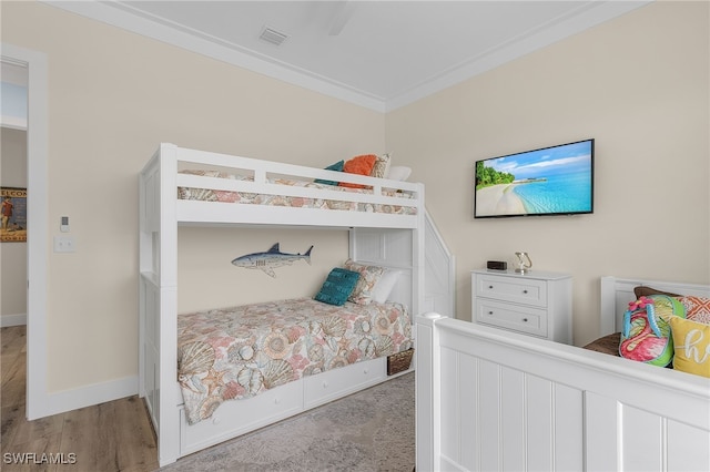 bedroom with light wood-type flooring and ornamental molding