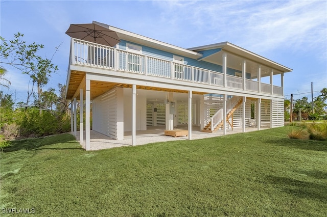 rear view of house featuring a lawn and a patio area