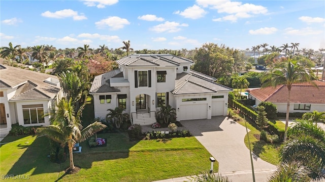 view of front of property featuring a garage and a front yard