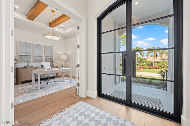 entryway featuring light hardwood / wood-style flooring and beamed ceiling