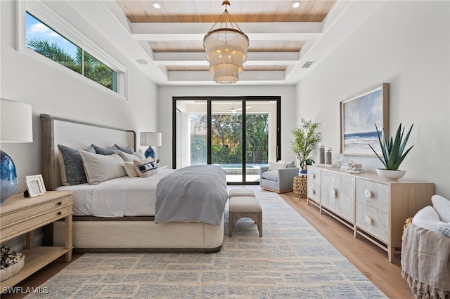 bedroom with access to exterior, light hardwood / wood-style floors, and beamed ceiling