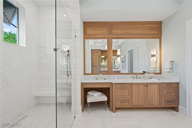 bathroom featuring a tile shower and vanity