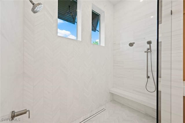 bathroom with a tile shower