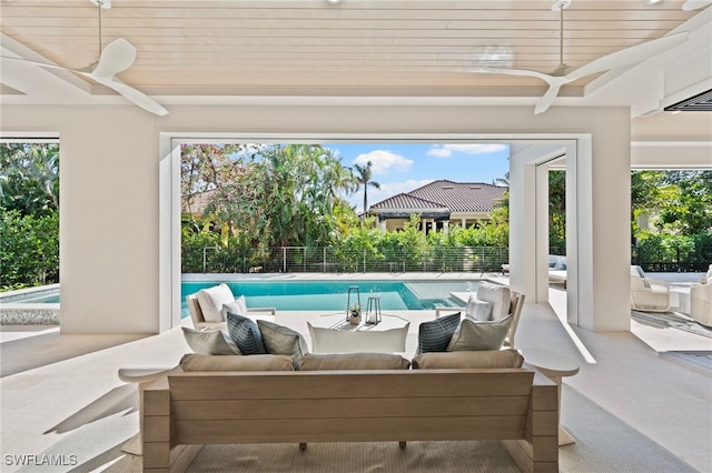 view of patio / terrace with a fenced in pool, an outdoor hangout area, and ceiling fan