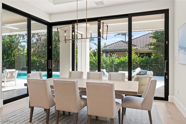 dining area with hardwood / wood-style flooring and a chandelier