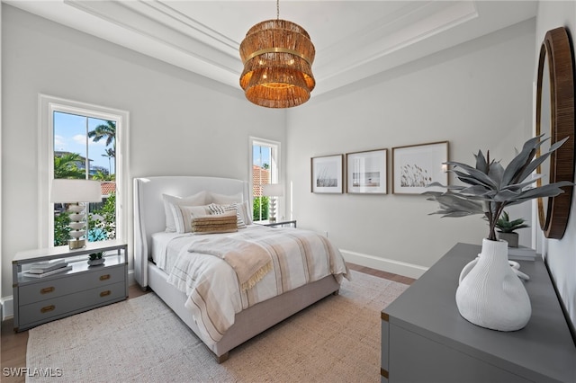 bedroom with a notable chandelier and wood-type flooring