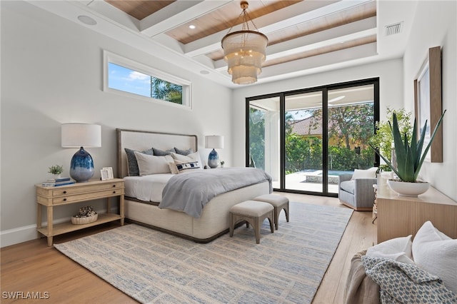 bedroom with beamed ceiling, access to exterior, a chandelier, and light hardwood / wood-style floors