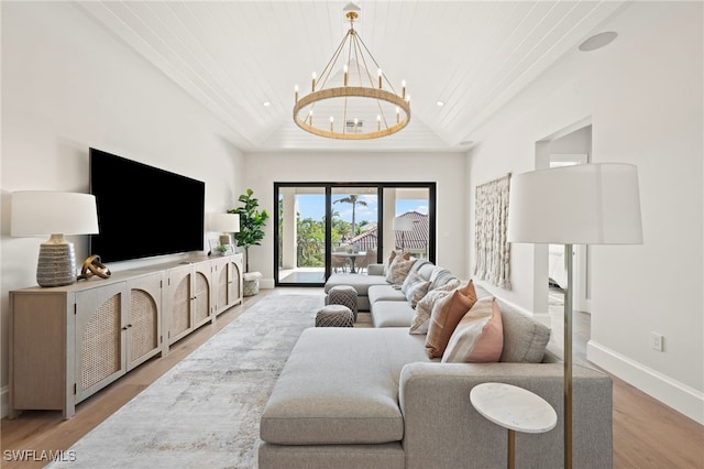 living room featuring hardwood / wood-style flooring, high vaulted ceiling, a notable chandelier, and wood ceiling