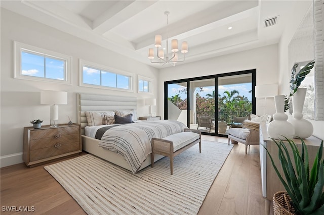 bedroom with beamed ceiling, access to exterior, a chandelier, and light hardwood / wood-style flooring