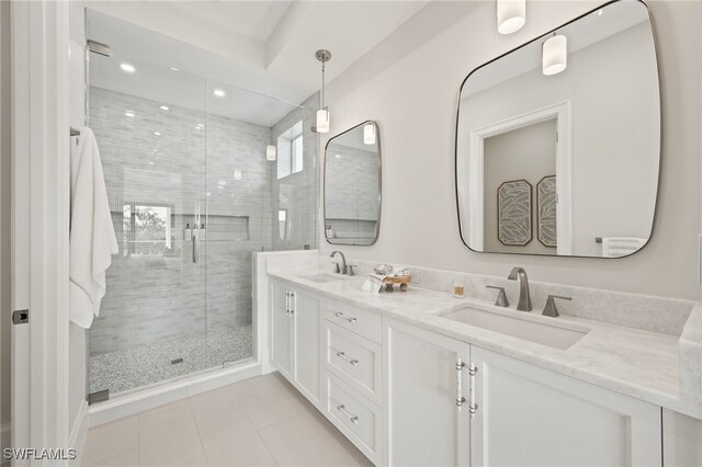 bathroom featuring vanity, tile patterned flooring, and a shower with door