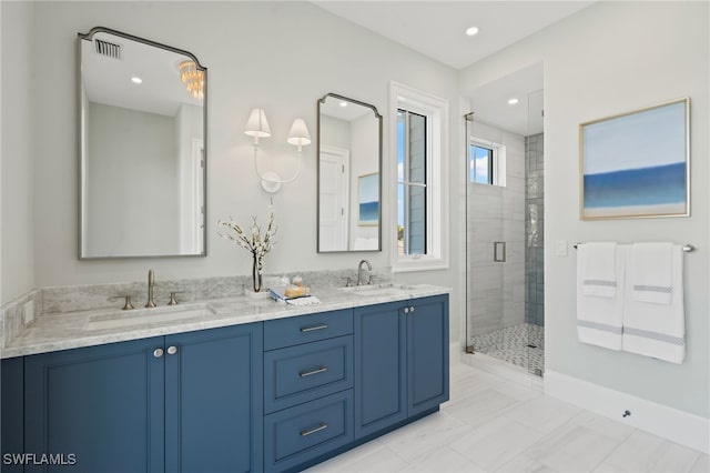 bathroom with vanity and a shower with door