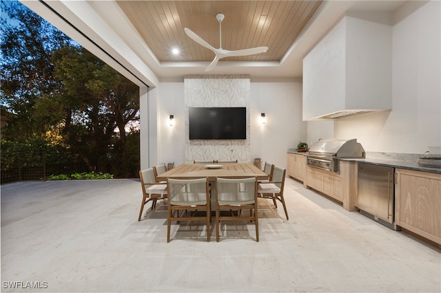 view of patio with ceiling fan, an outdoor kitchen, and a grill