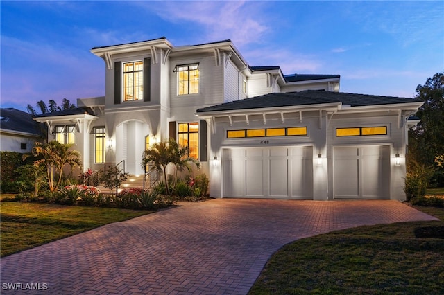 view of front of property featuring a garage and a yard