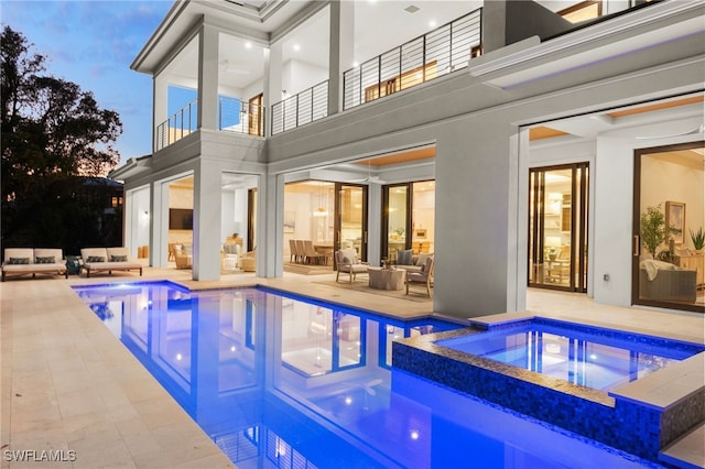 view of pool featuring a patio area, outdoor lounge area, and an in ground hot tub