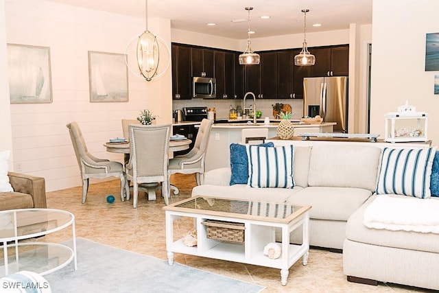 living room featuring sink and light tile patterned flooring