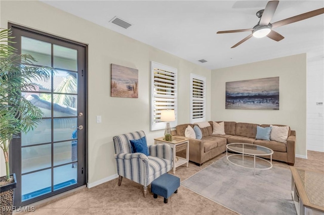 tiled living room with ceiling fan