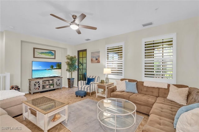 living room with ceiling fan and plenty of natural light