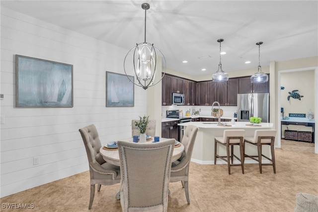 dining room featuring sink and an inviting chandelier