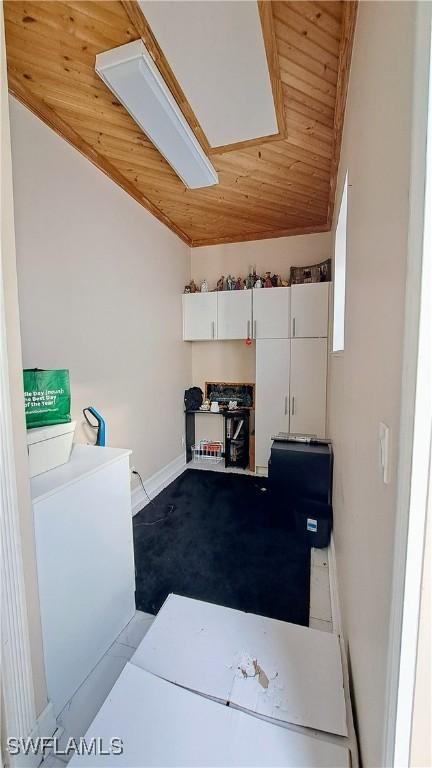 laundry area featuring wooden ceiling and washer / dryer