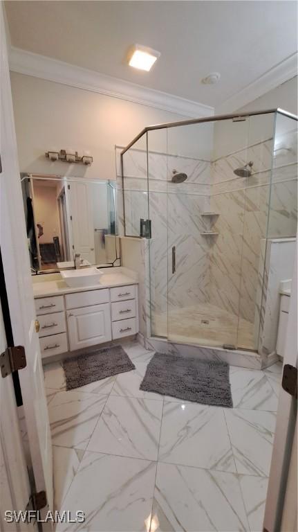 bathroom with crown molding, walk in shower, and vanity