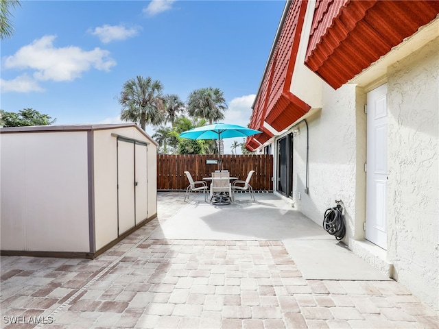 view of patio / terrace with a shed