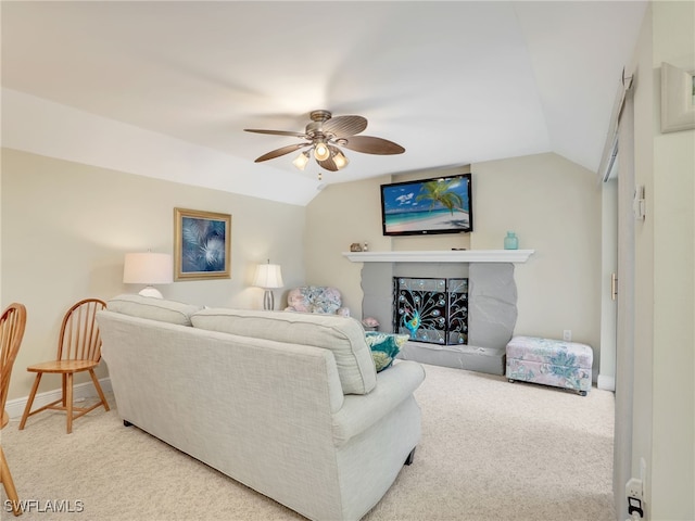 carpeted living room with ceiling fan and lofted ceiling