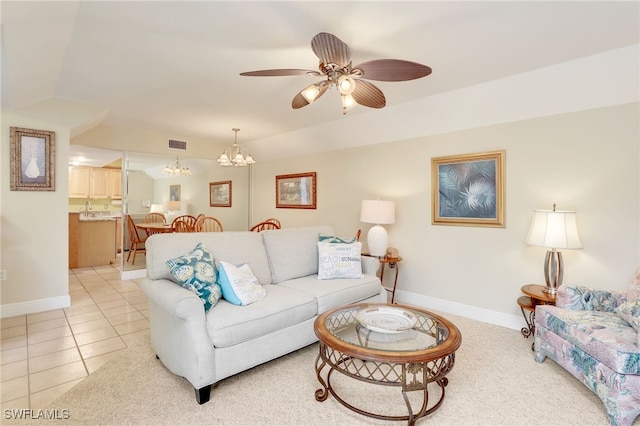 tiled living room featuring ceiling fan with notable chandelier and vaulted ceiling