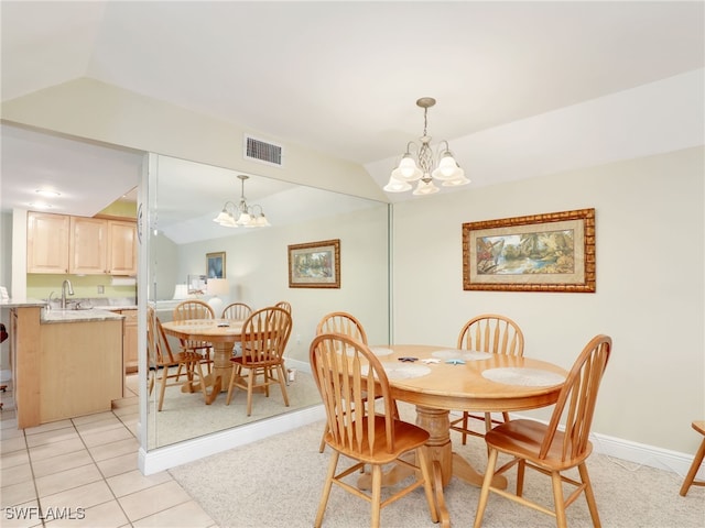 tiled dining room featuring vaulted ceiling, sink, and a chandelier