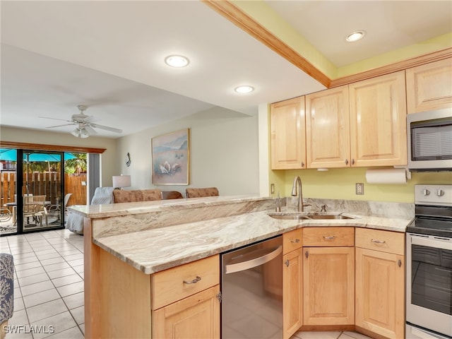 kitchen with sink, kitchen peninsula, stainless steel appliances, and light brown cabinetry