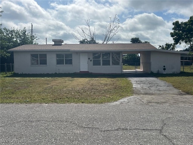 single story home with a front yard and a carport